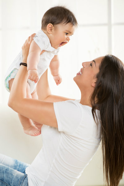 Mother Lifting Smiling Child