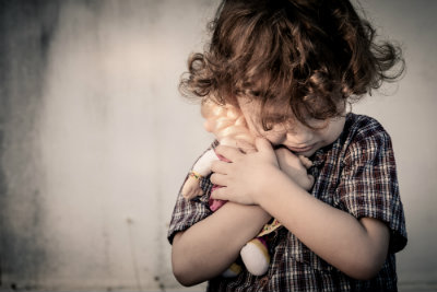 Frightened Child Hugs His Toy