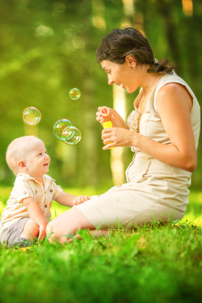 Summer can give you lots of ideas for fun with your baby, like blowing bubbles.