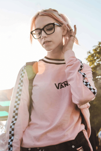 blonde woman in pink shirt walks while thinking