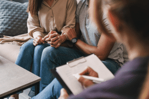young parents sit with parenting consultant
