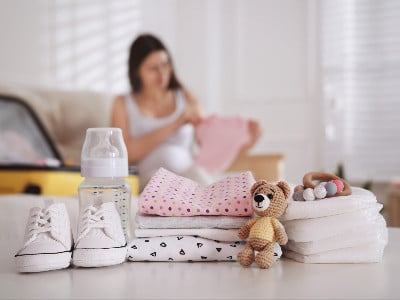 Pregnant woman packing baby supplies