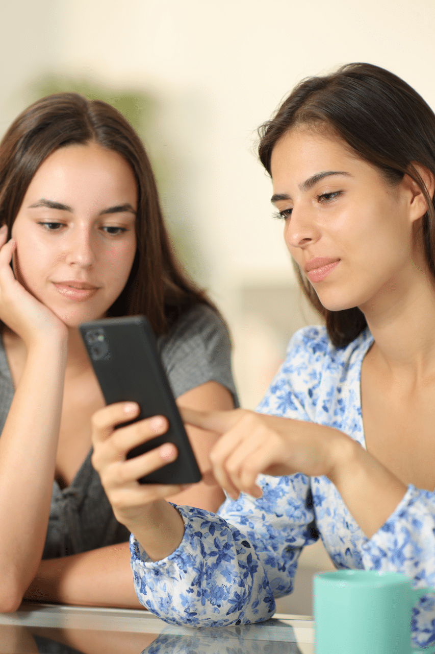 female friends searching on cell phone