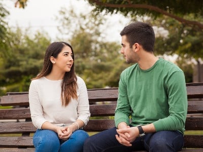 Couple on bench in serious discussion
