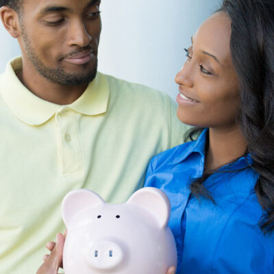 Couple Holding Piggy Bank