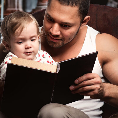 Dad Reading To Daughter
