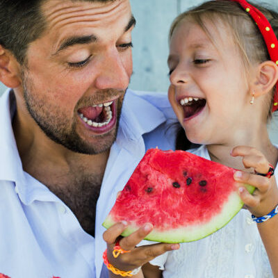 Dad and Daughter Easting Watermellon