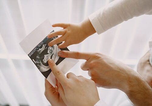 Family Enjoying Ultrasound Photo