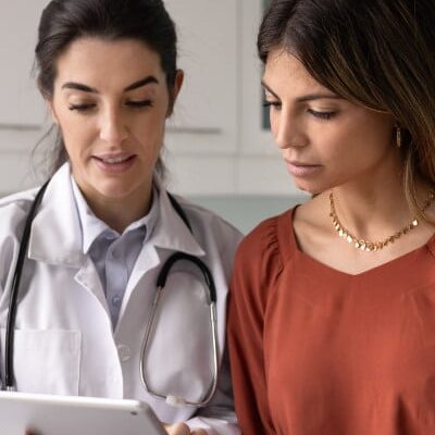 Female patient talks with nurse before appointment