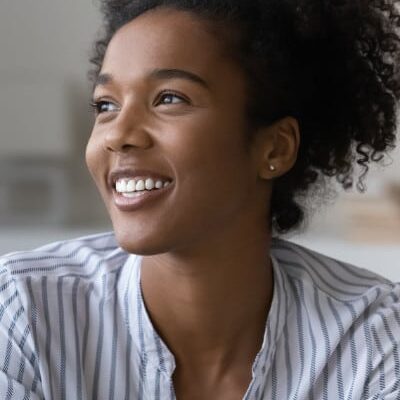 young black woman smiles wearing striped shirt