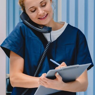 Nurse talks on phone to client about their confidential STI test results.