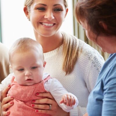 young mother and baby get supportive education from woman